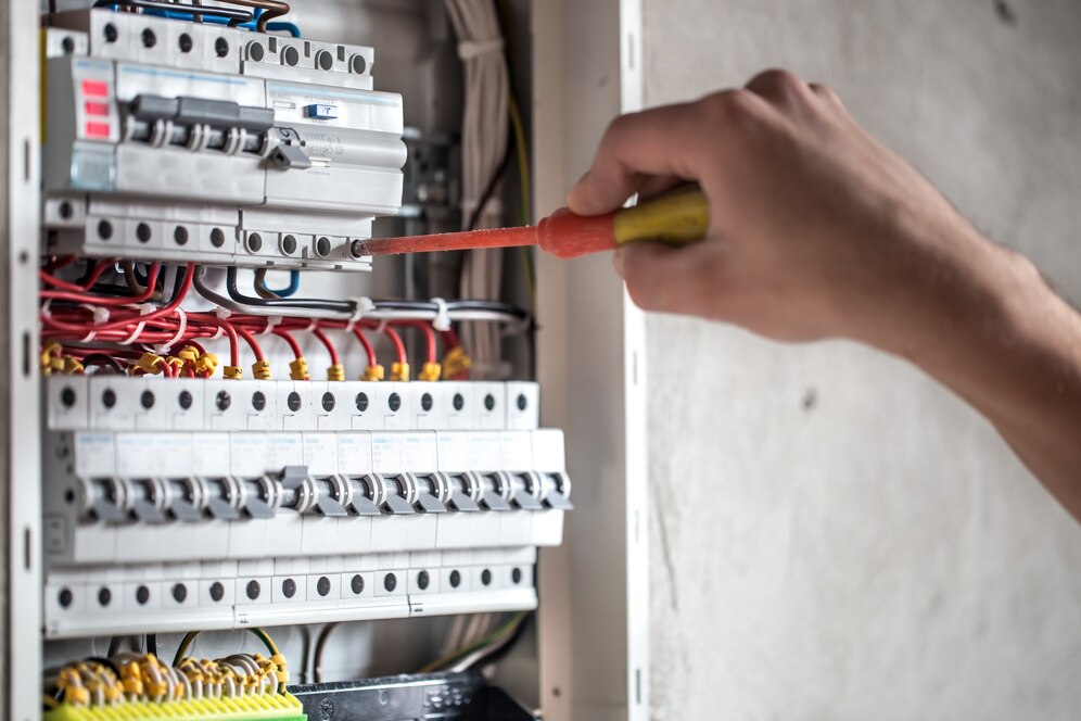 man electrical technician working switchboard with fuses installation connection electrical equipment close up_169016 5077